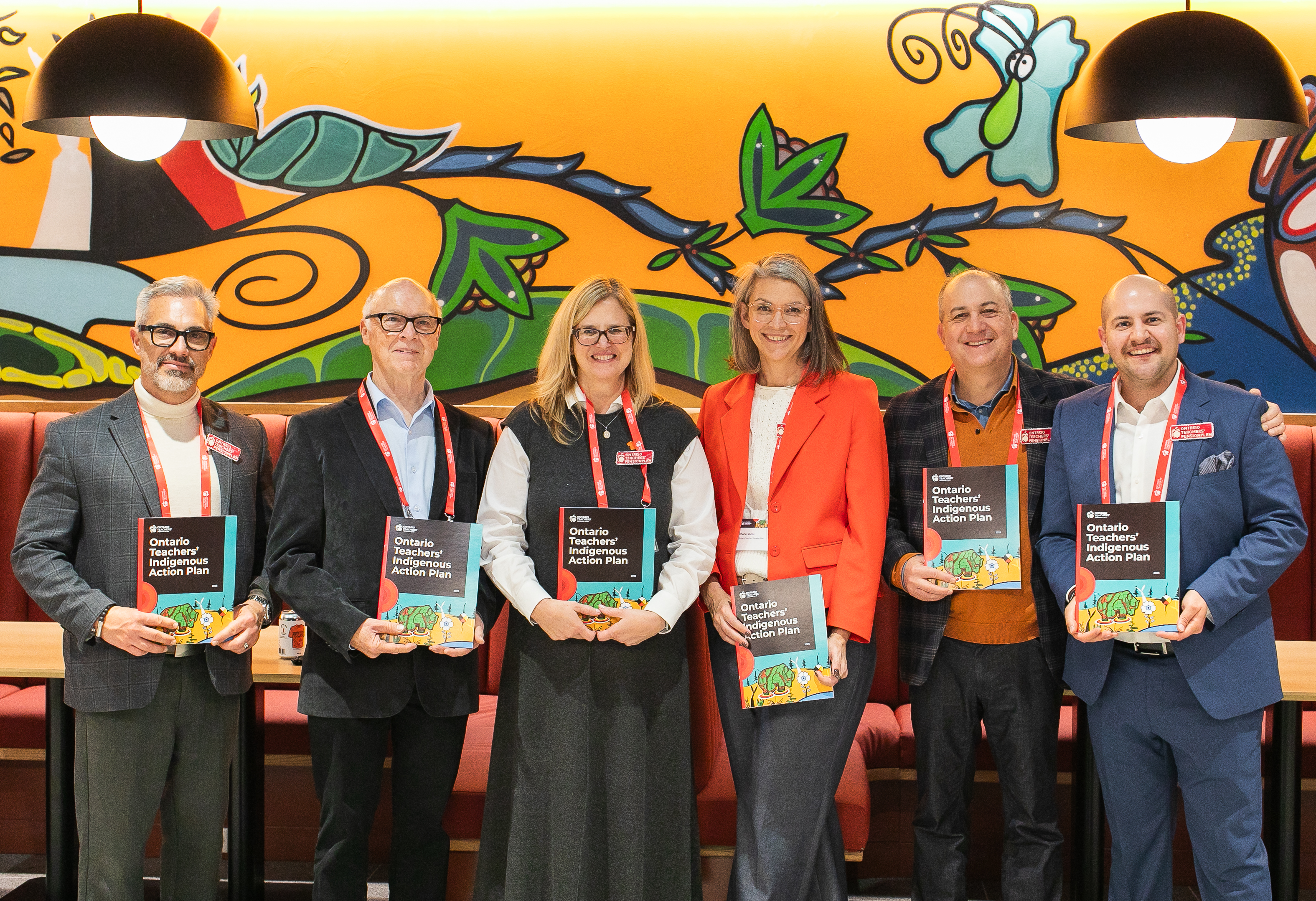 group photo in front of painting